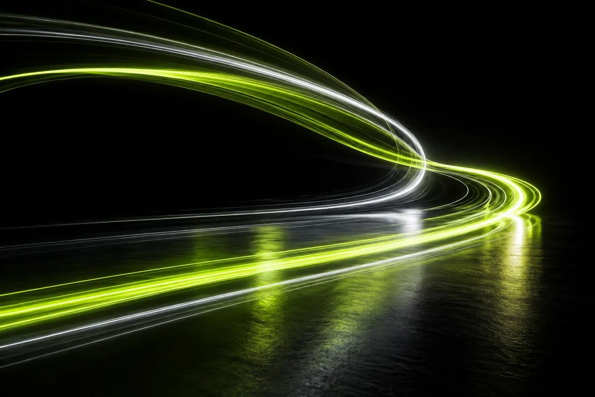 Long-exposure light trails in lime and white sweeping smoothly through a dark space